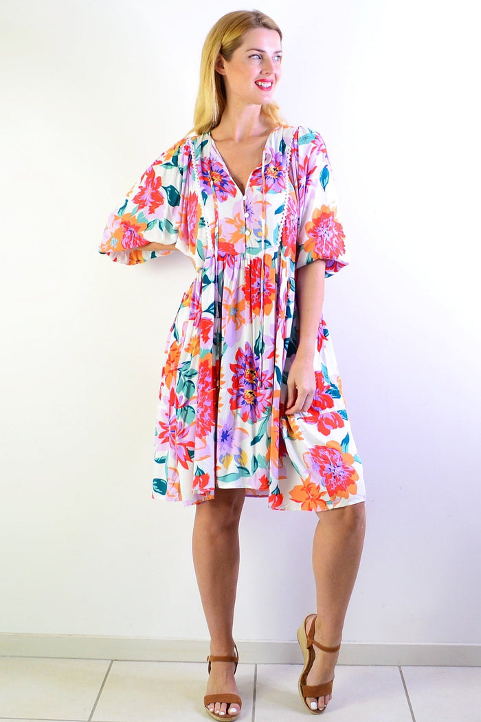 White tropical garden dress tunic by New U Collection with floral pattern and relaxed fit, displayed on a hanger.