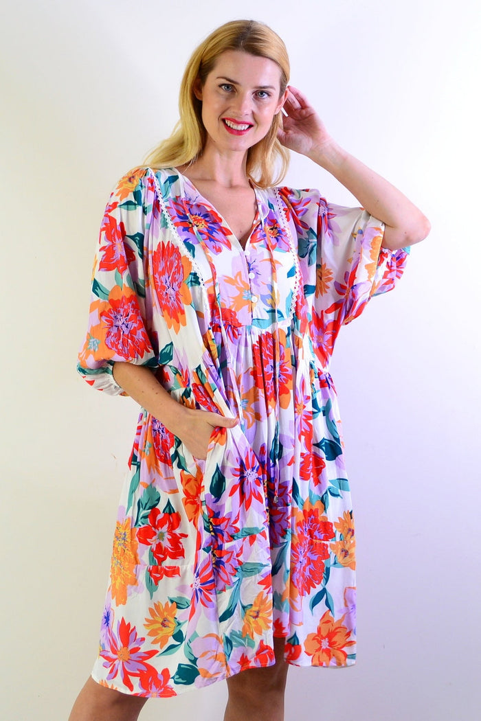 White tropical garden print tunic from New U Collection featuring a flowy design and lightweight fabric.