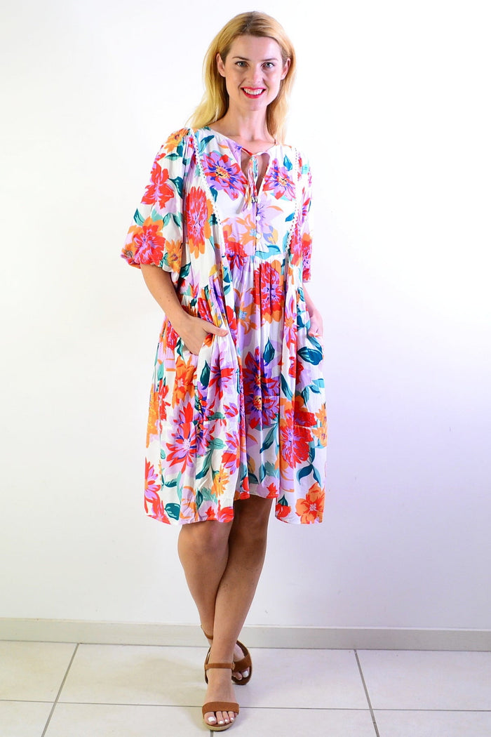 White tropical garden tunic dress from New U Collection featuring floral print and lightweight fabric.