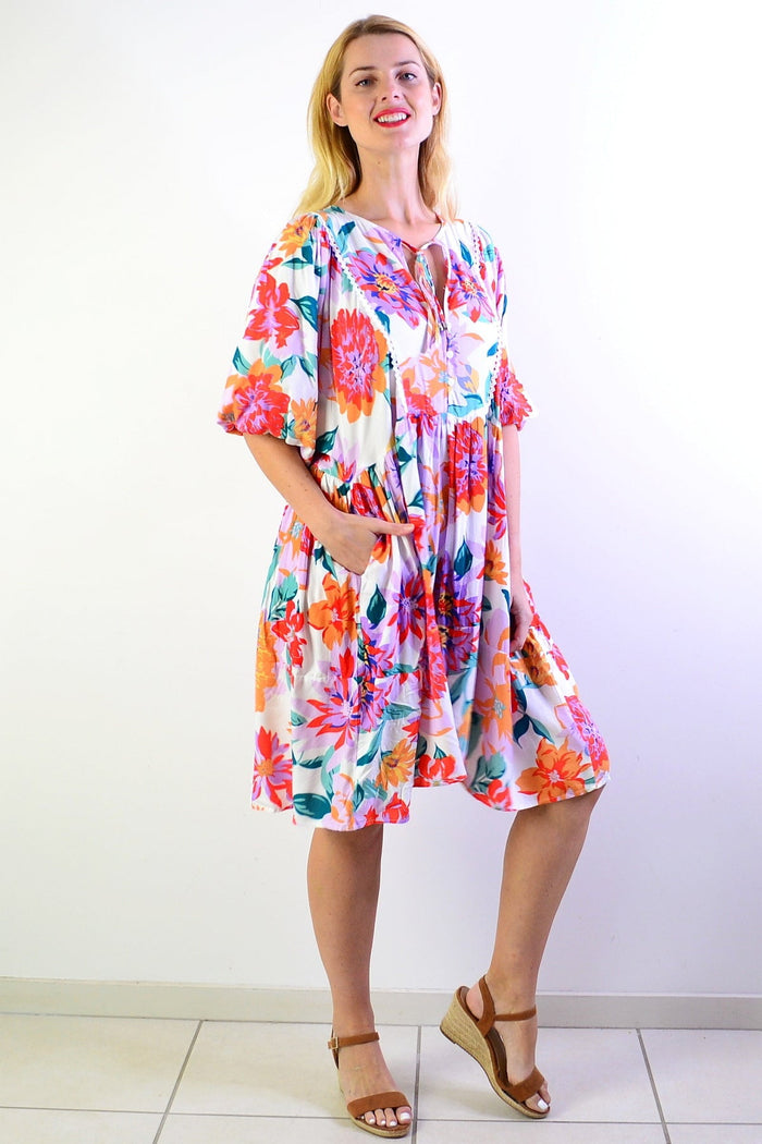 White Tropical Garden Dress Tunic by New U Collection, featuring floral patterns and lightweight fabric, displayed on a hanger.