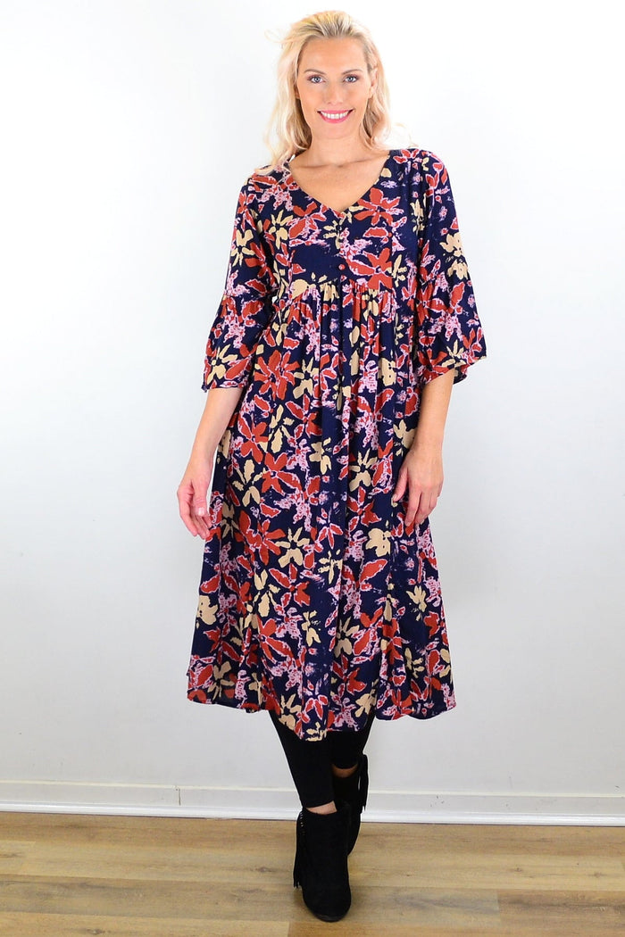 Winter Leaves Midi Tunic Dress by Hourglass, featuring a floral leaf pattern and flowing silhouette, displayed on a hanger.