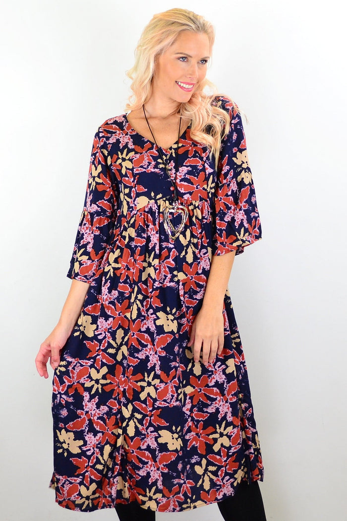 Hourglass Winter Leaves Midi Tunic Dress, flowy fabric with leaf pattern, displayed on a hanger against a neutral background.