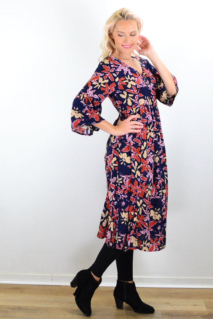 Hourglass Winter Leaves Midi Tunic Dress in fabric with a leaf pattern, featuring a relaxed fit and long sleeves.