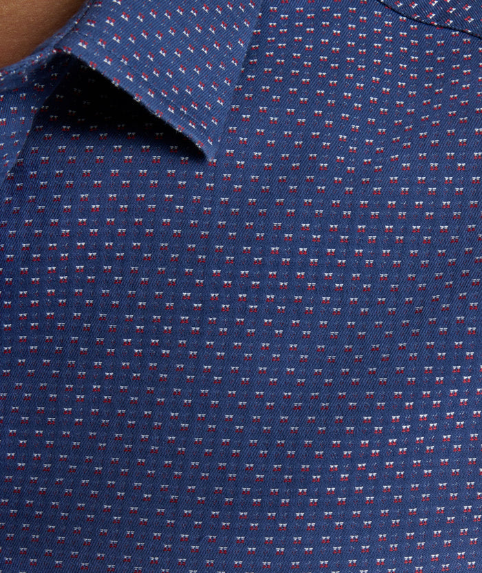 Model is wearing UNTUCKIt Rigby wrinkle-free shirt in navy print.